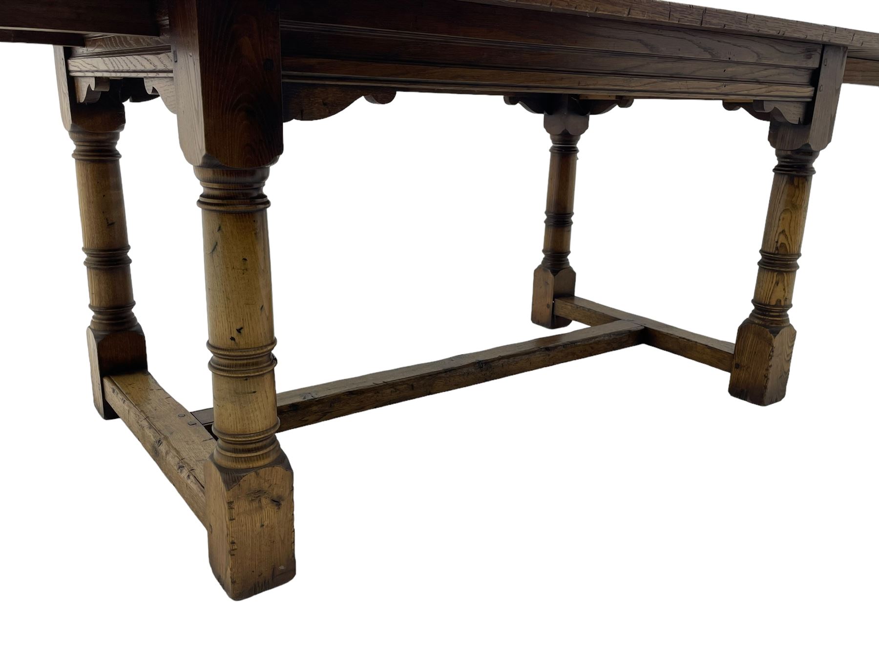 Oak refectory dining table, rectangular three plank top with cleated ends, two additional leaves, on turned supports united by H-stretchers 