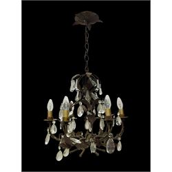 Early 20th century wrought metal chandelier, of scrolled form with six branches, decorated with leafage and glass pendants 