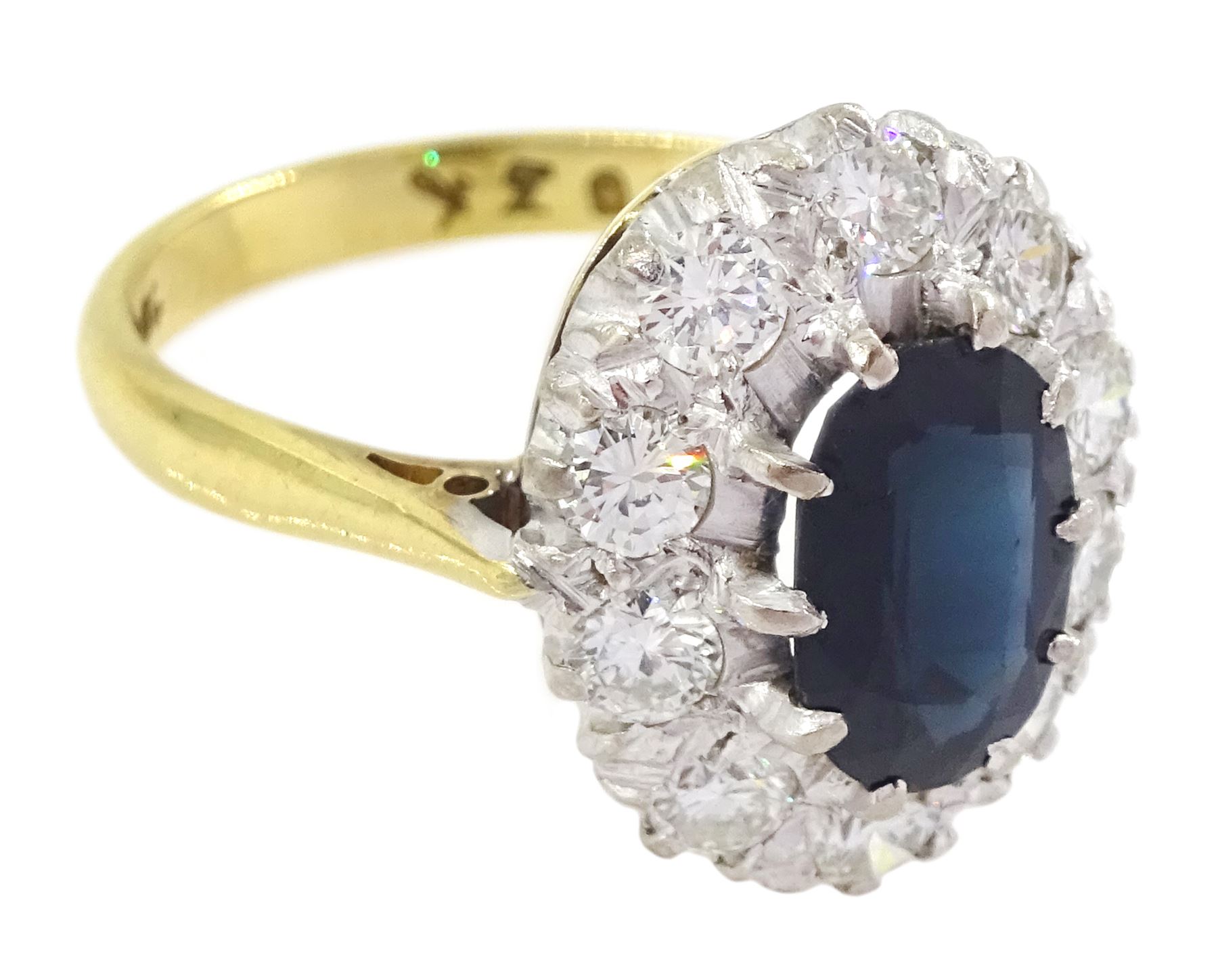 18ct gold oval cut sapphire and round brilliant cut diamond cluster ring, stamped, sapphire approx 1.20 carat, total diamond weight approx 0.80 carat