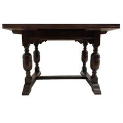 Mid-20th century medium oak dining table, rectangular draw-leaf extending top, quadruple turned pillar supports on sledge feet joined by stretcher