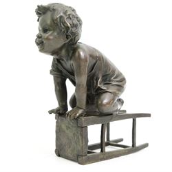 After Juan Clara (Spanish 1875-1957) - Bronze of a child playing on an upturned stool H15cm, signed underneath stool 