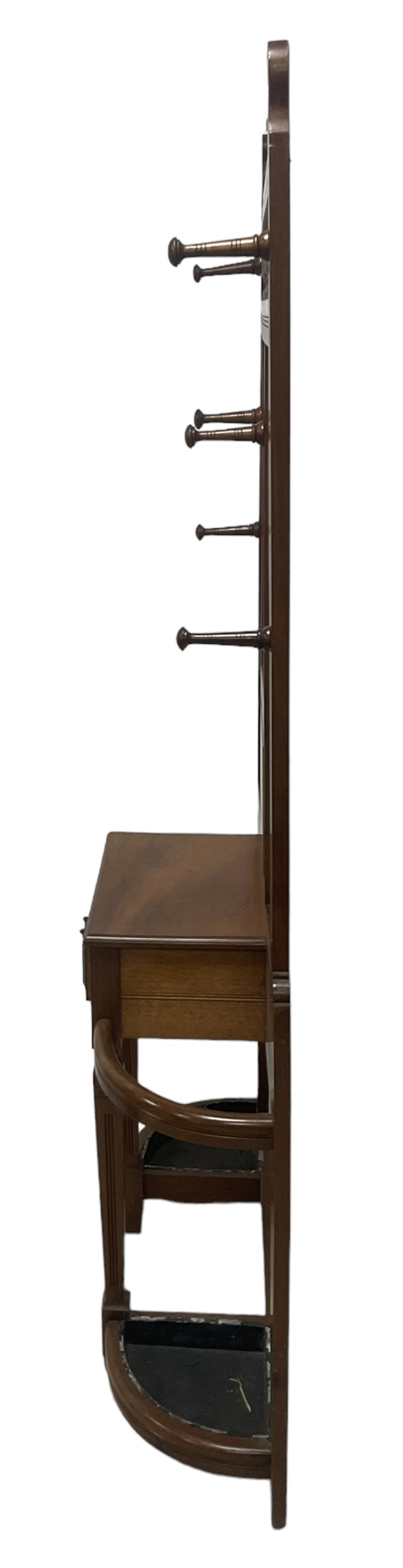 Late Victorian hallstand, raised pediment over balustrade frieze, bevelled mirror back with coat hooks over glove drawer, fitted with two drip-trays to base