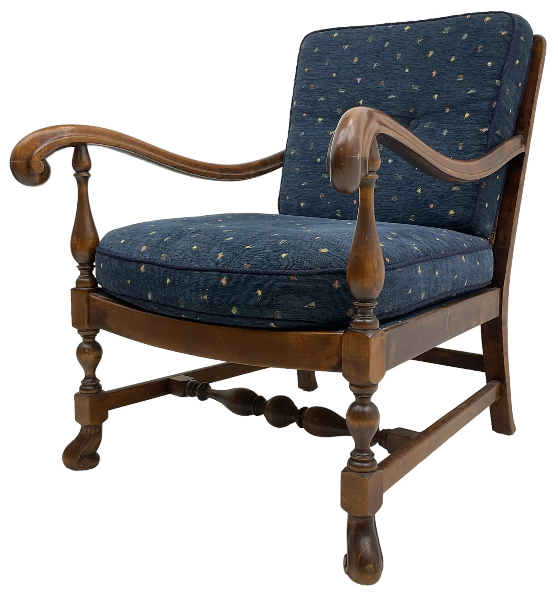 Early 20th century stained beech framed armchair, cane panel back over scrolled arm terminals, raised on turned supports united by turned H-stretcher, with patterned blue upholstered loose back and seat cushions