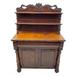 Victorian mahogany chiffonier, raised shaped pediment carved with scrolled extending foliage, two graduating shelves on turned supports, rectangular top over drawer and double cupboard, turned column pilasters, on turned feet 