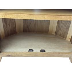 Light oak corner television unit, hexagonal top over recess with rear cable hole, fitted with two panelled doors to base and brass knobs 