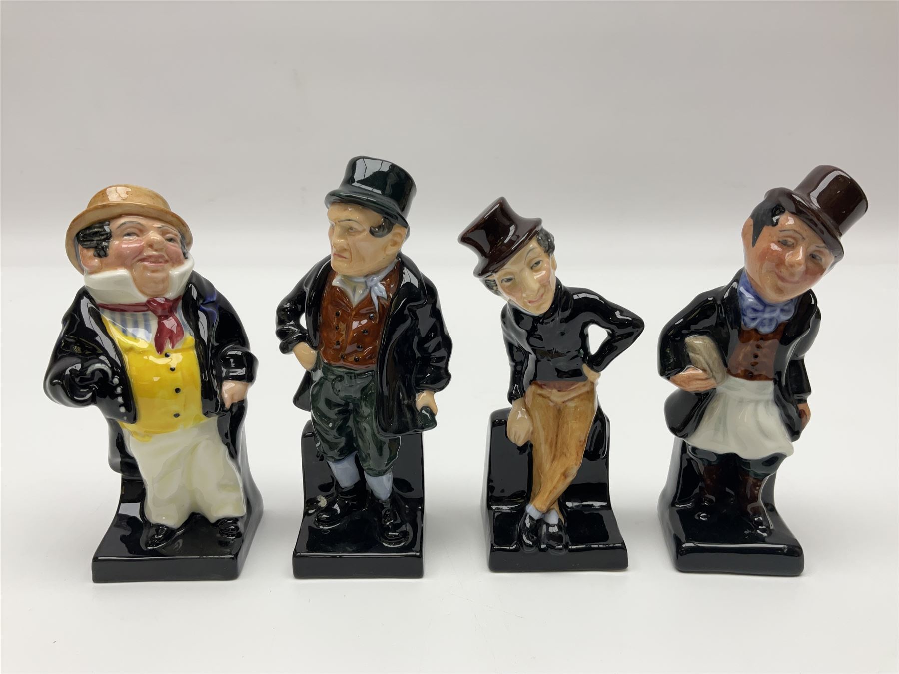 Twenty four Royal Doulton figures of characters from the works of Charles Dickens, to include Sam Weller, Pecksniff, Oliver Twist, Sairey Gamp, Artful dodger etc