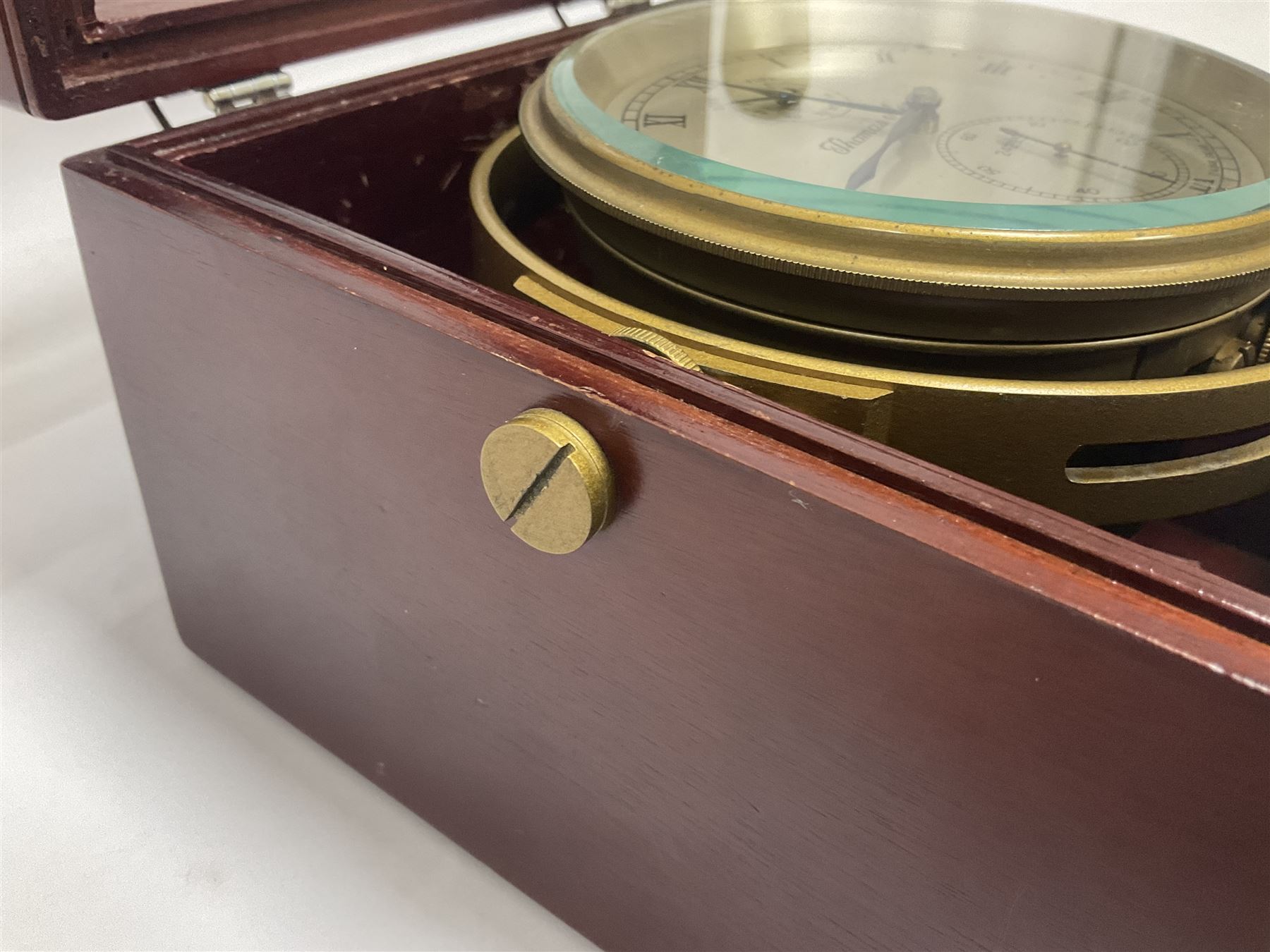 Two-day marine chronometer, with silvered dial inscribed Thomas Mercer Ltd, St Albans, contained within a brass gimbal-mounted bowl and glazed mahogany case, with applied brass plaque reading 'supplied by Kelvin Hughes no. 24295', brass winding key and two service notes to interior of case, dial D12cm, wooden case H17.5cm 