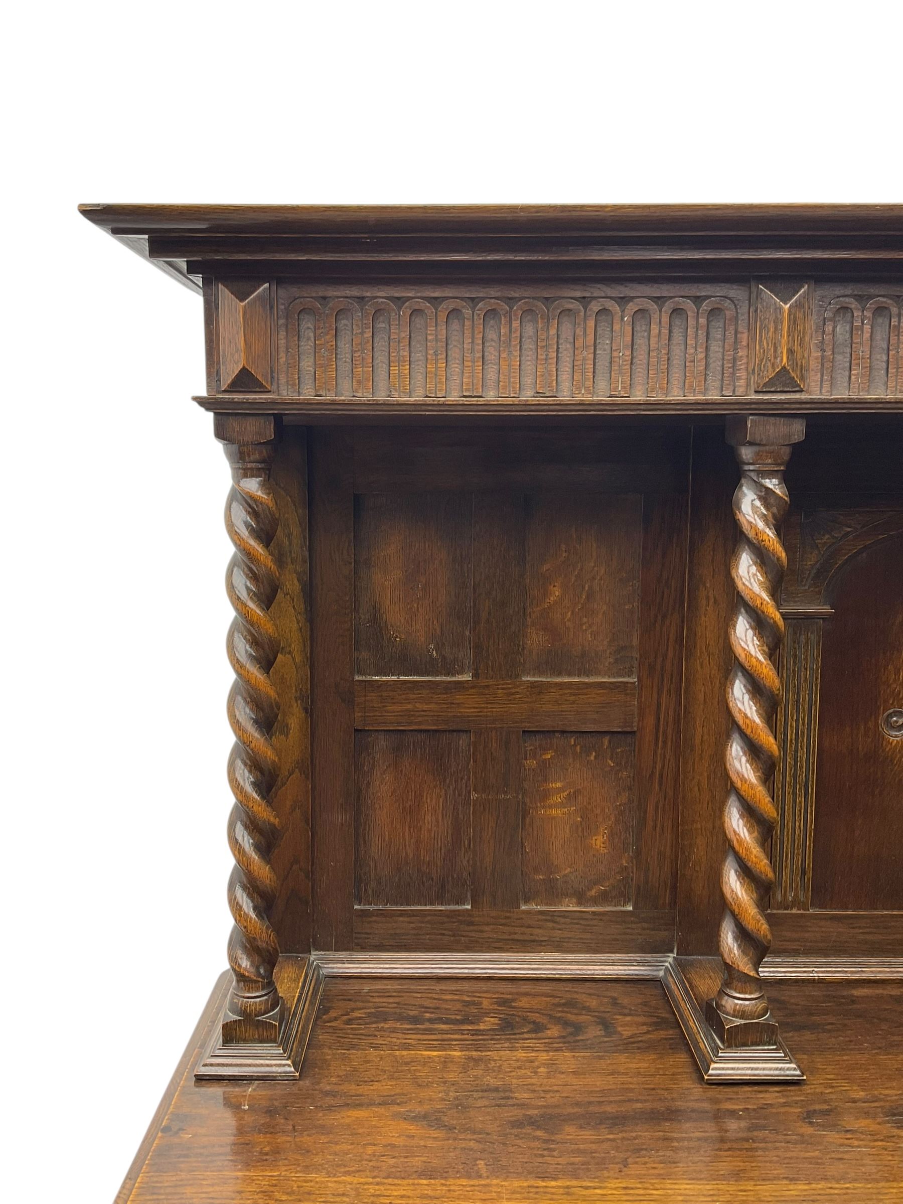 Jacobean Revival oak dresser, projecting moulded cornice over arcade carved frieze and panelled back, on spiral turned supports, moulded rectangular top over two cupboards and two drawers, on spiral turned supports united by moulded stretchers 