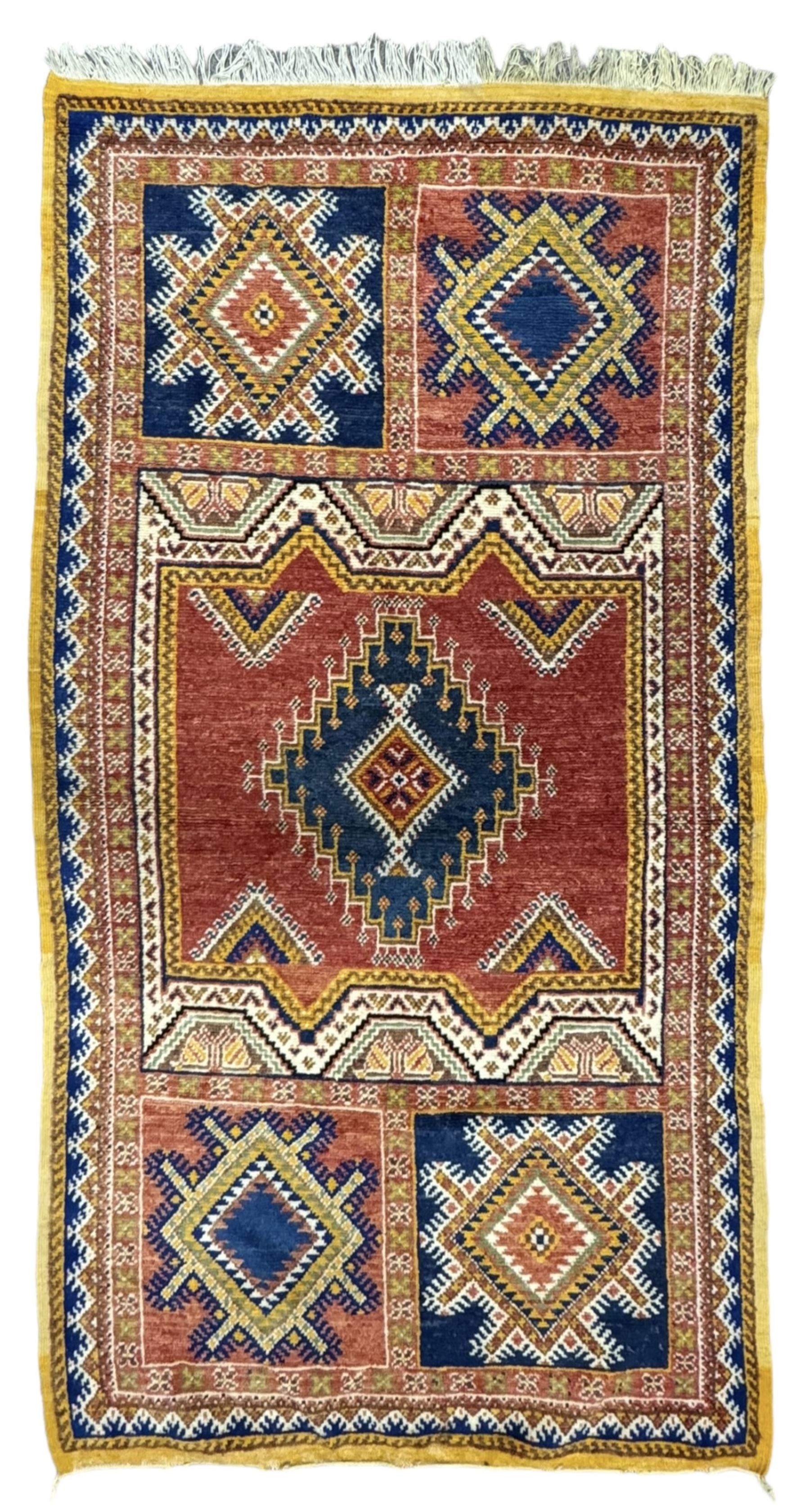 Persian Qashqai crimson ground rug, the field with central indigo and yellow medallion with geometric motifs, flanked by smaller medallions, border with repeating patterns (112cm x 200cm); Turkish Kazak light blue ground rug (109cm x 193cm); red ground runner with three octagonal medallions (69cm x 138cm)