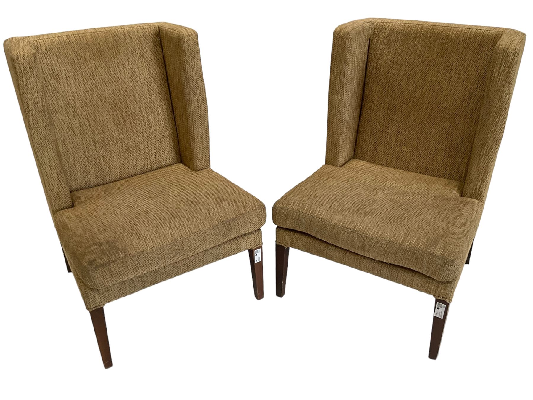 Two wing back armchairs, upholstered in oatmeal fabric