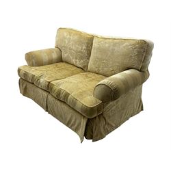 Contemporary two-seat sofa, upholstered in damask fabric with a pale gold floral pattern, rolled arms, loose back and seat cushions, on matching skirted base with concealed castors