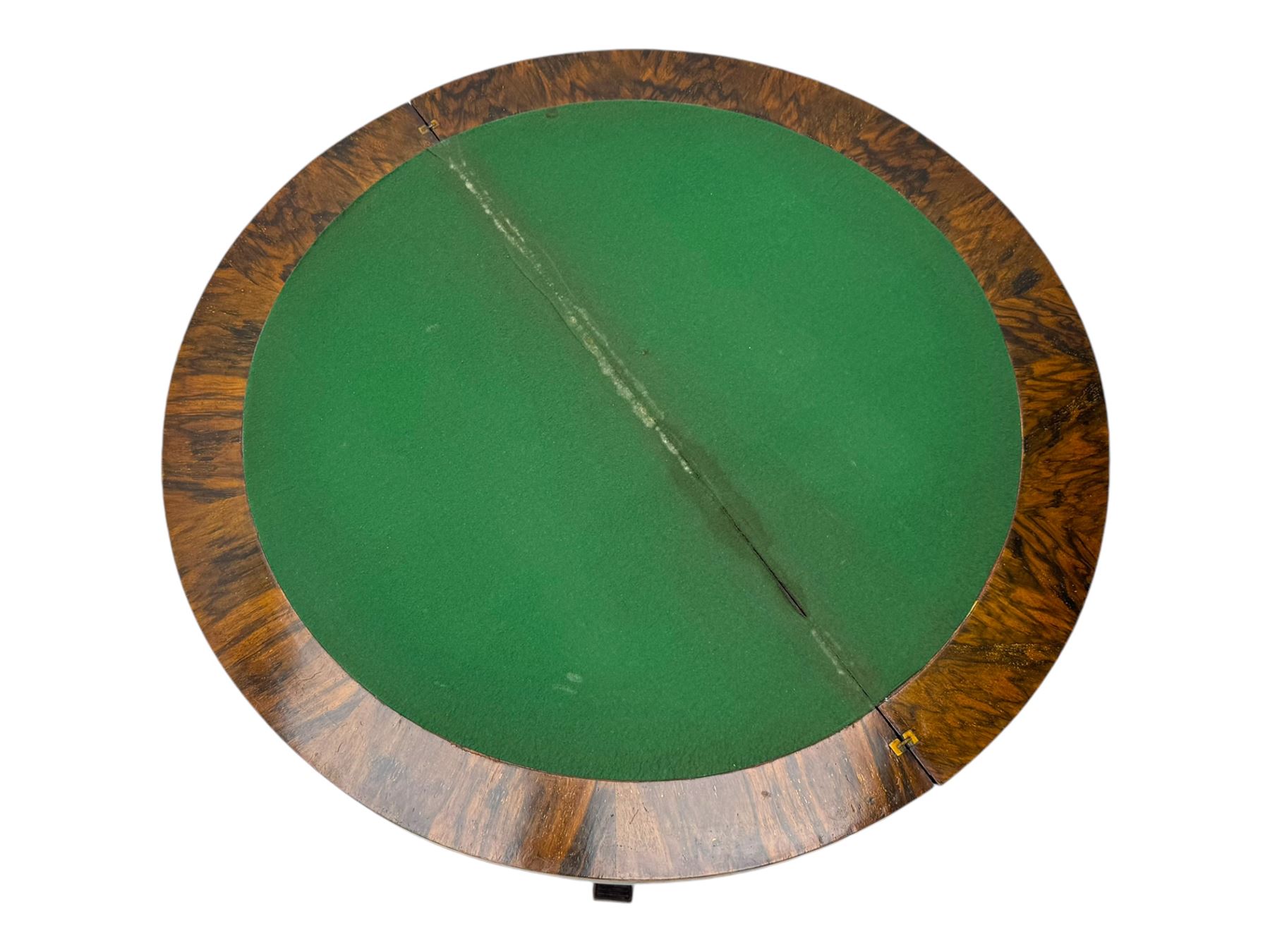 Victorian walnut demi-lune card table, circular fold-over top with foliate carved edge, revealing green baize-lined playing surface over scalloped apron, raised on a turned and carved pedestal with four splayed scroll supports with castors