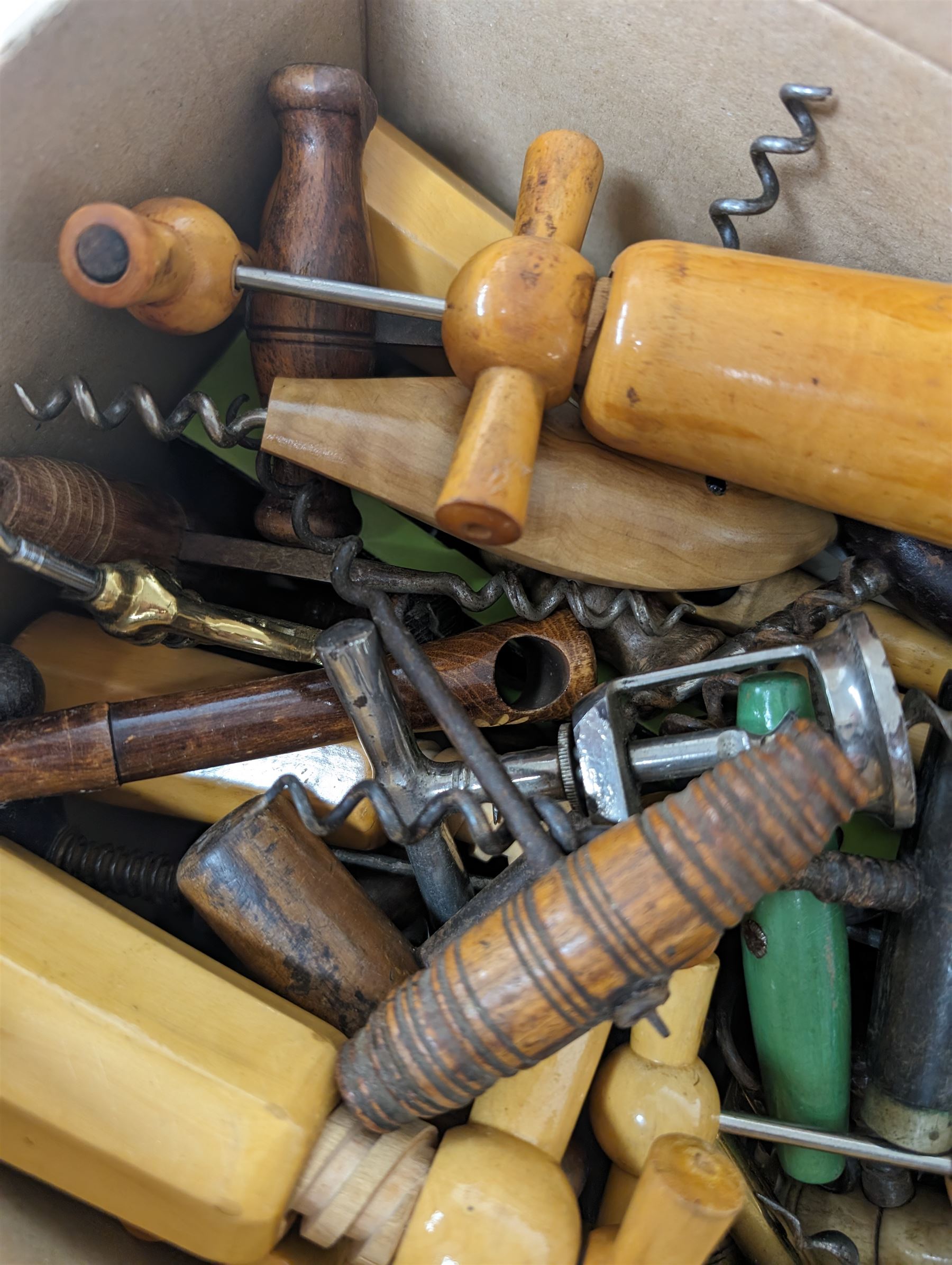 Collection of approximately fifty seven corkscrews, including turned wooden and metal examples