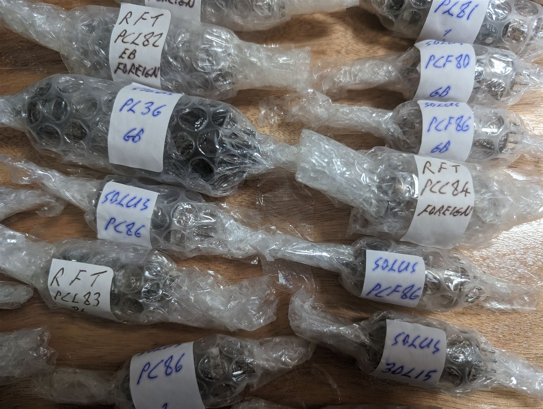 Large collection of thermionic valves/vacuum tubes, by various makers, mostly wrapped in bubble wrap with identifying stickers, together with a collection of empty valve boxes including Pinnacle, Mullard etc