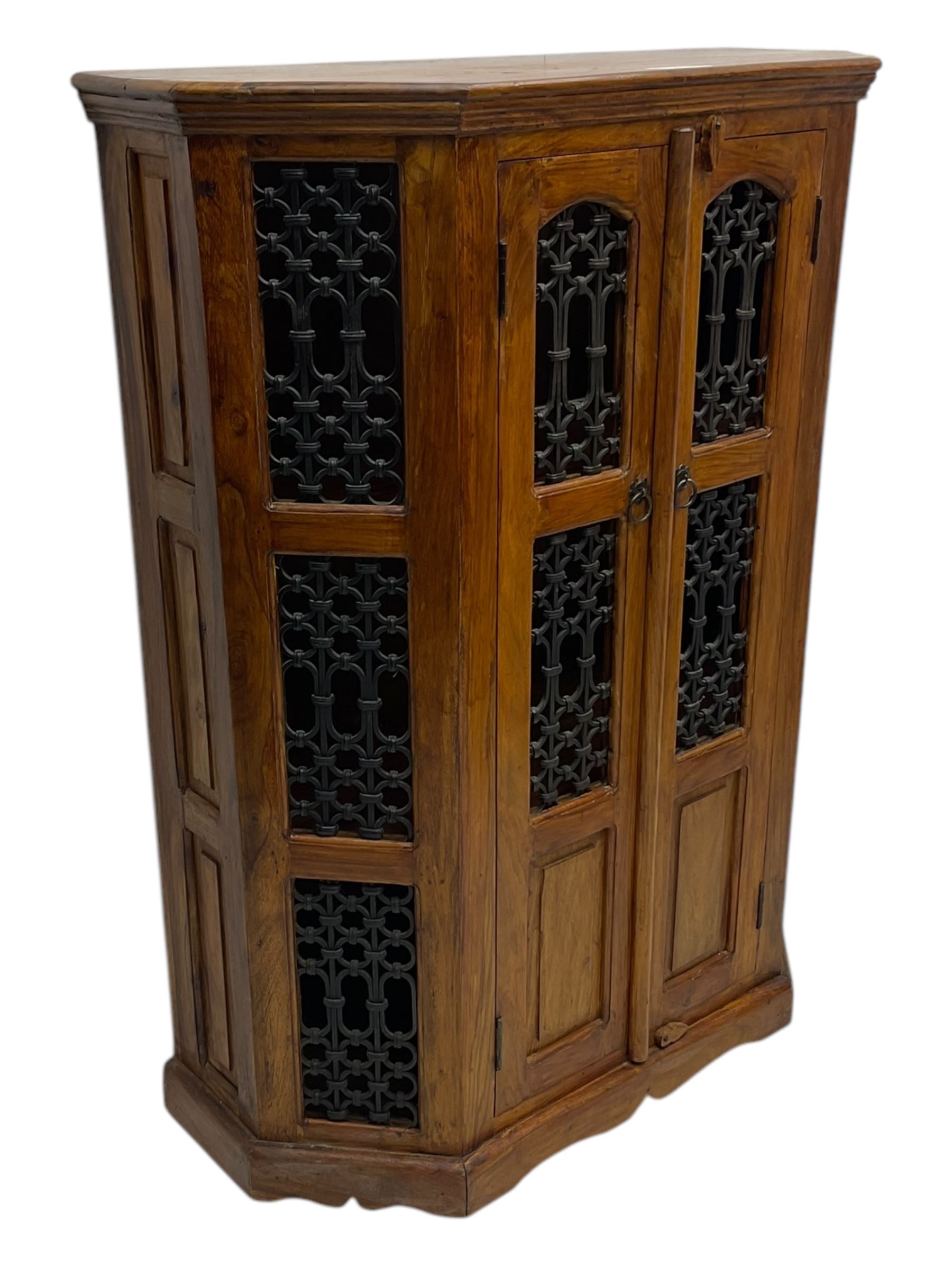 Hardwood and wrought iron cabinet, enclosed by two doors, on plinth base 