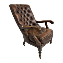 Georgian design mahogany framed library armchair, upholstered in buttoned chocolate brown leather with studwork and loose seat cushion, raised on turned supports with brass castors