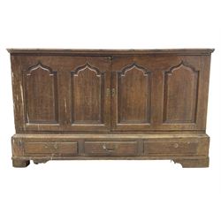 Georgian oak converted mule chest, rectangular plank top over two cupboards with arched Gothic motif panels enclosing storage area with shelves, the base with three drawers with pull handles, on shaped bracket feet