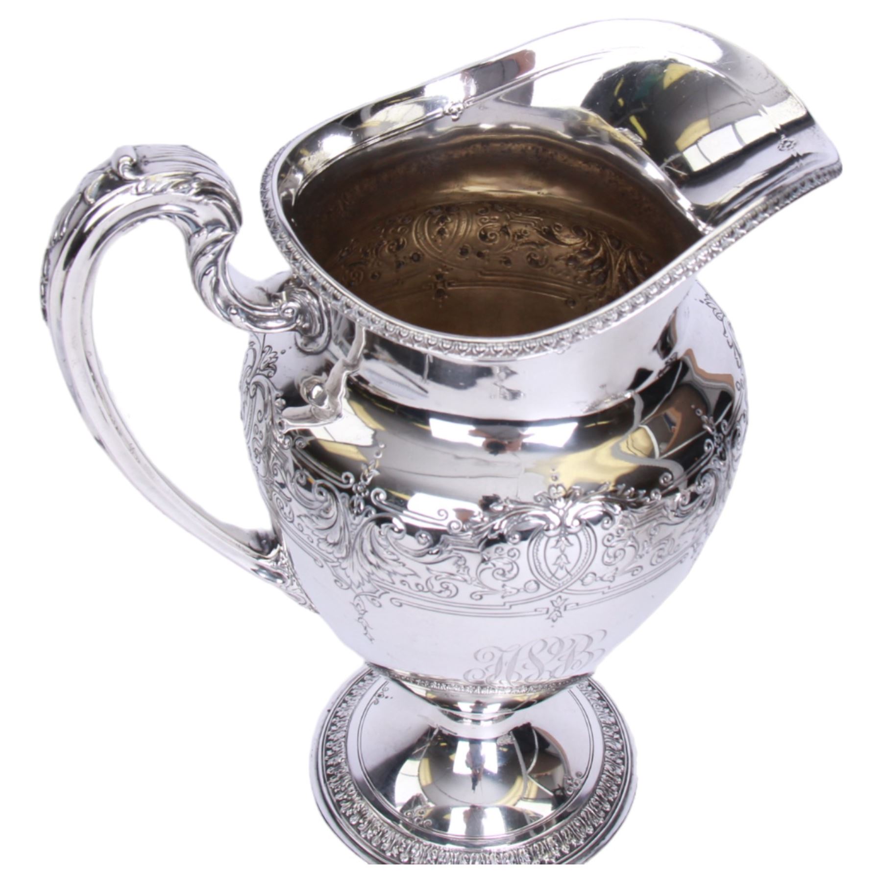 Large late 19th/early 20th century American silver pitcher, the body of ovoid form with embossed and chased foliate band, and acanthus capped scroll handle, upon a spreading circular foot with stiff leaf border, marked for Reed & Barton, Taunton, Massachusetts, and stamped Sterling, H27cm

