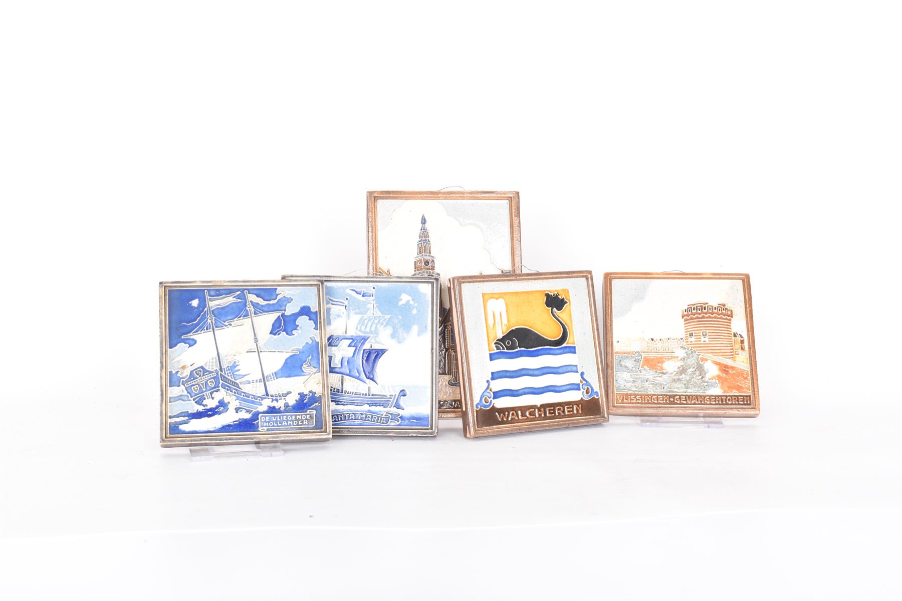 Five Dutch Westraven tiles, to include four square examples depicting maritime and similar scenes, and a rectangular example depicting a village scene, square tiles 10cm x 10cm, rectangular tile 15cm x 10cm