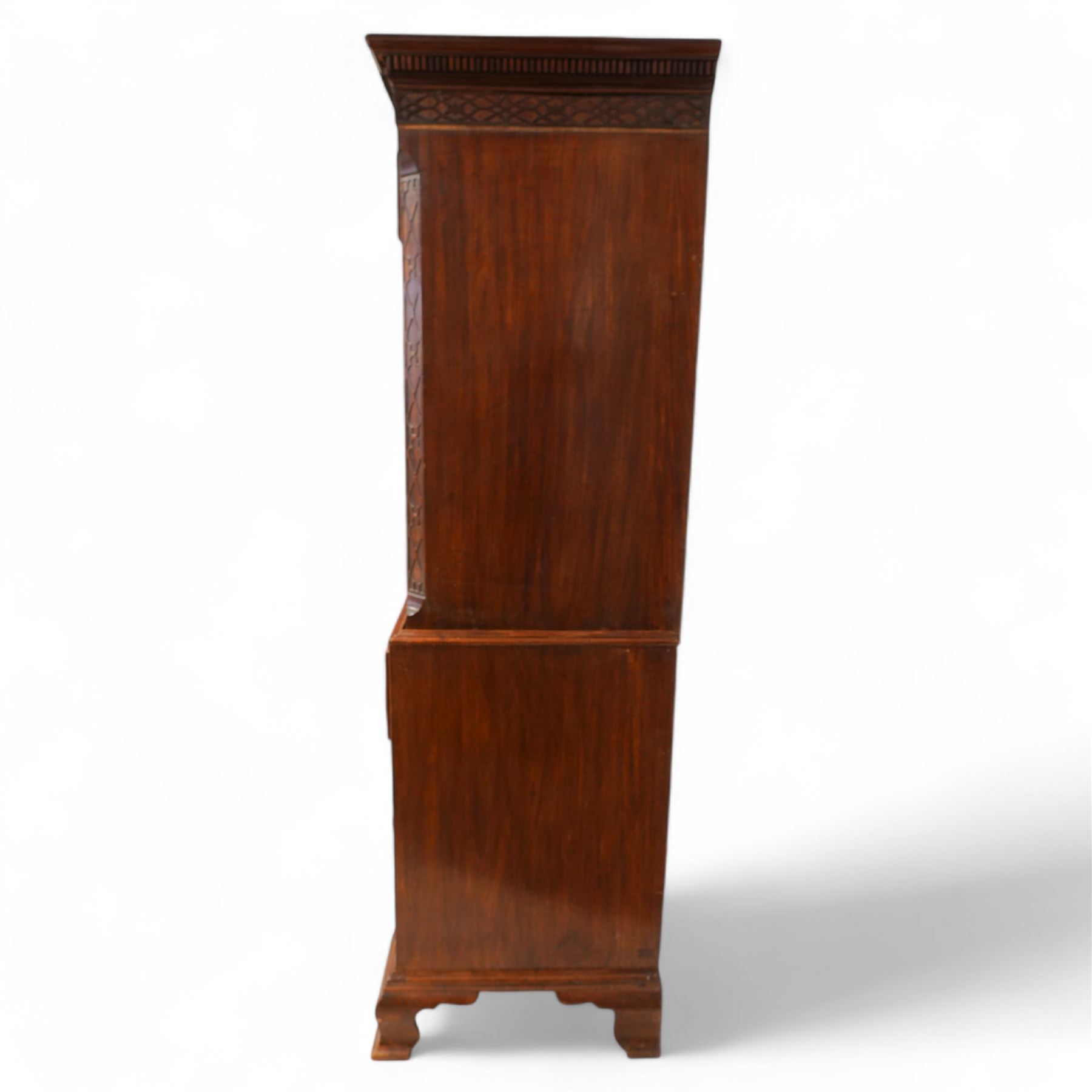 George III mahogany canted chest-on-chest, moulded cornice over three short and six long moulded drawers, shaped and pierced handle plates with swan neck handles, fluted upright canted corners, on bracket feet 