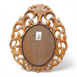 Florentine design gilt wall mirror, bevelled oval mirror plate surrounded by scrolling and interlaced acanthus leaves, curled leaf pediment 