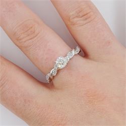 White gold single stone round brilliant cut diamond ring, with diamond set crossover design shoulders, hallmarked 9ct, total diamond weight 0.66 carat