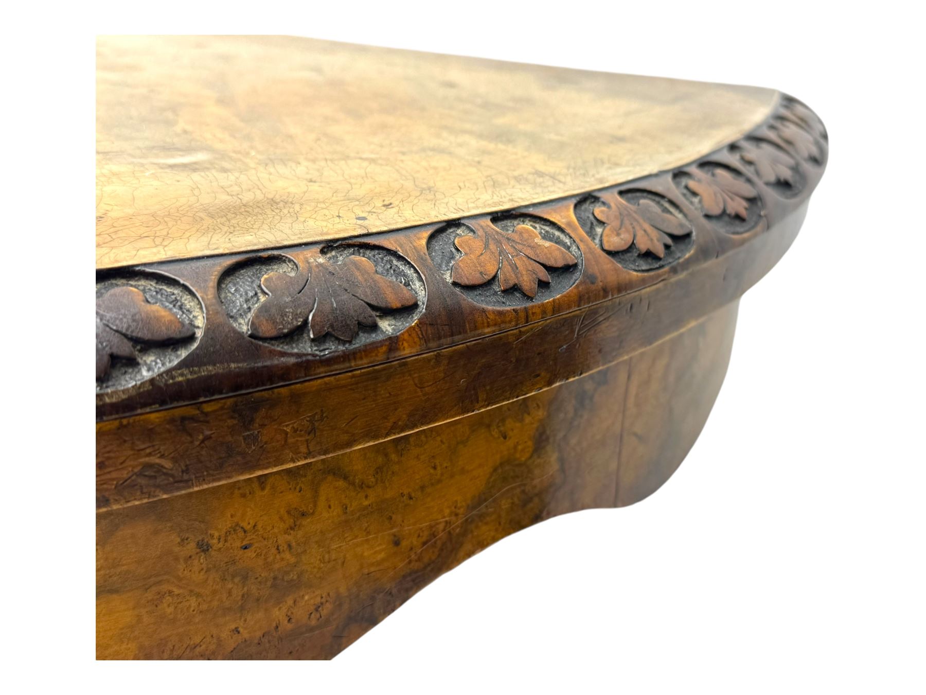 Victorian walnut demi-lune card table, circular fold-over top with foliate carved edge, revealing green baize-lined playing surface over scalloped apron, raised on a turned and carved pedestal with four splayed scroll supports with castors