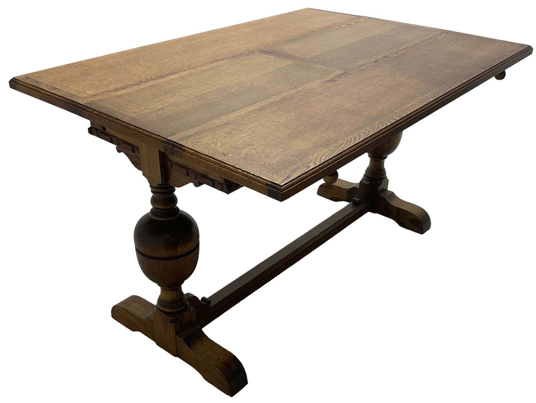 Early 20th century oak 'Ee-zi-Way one motion extending dining table', rectangular top over twin baluster end supports united by stretcher