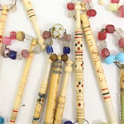 Collection of 19th century and later bone lace maker's bobbins, mostly engraved with names and spot incised blue and red decoration, others with brass wire work or turned shafts, most with glass spangles (60 approx)