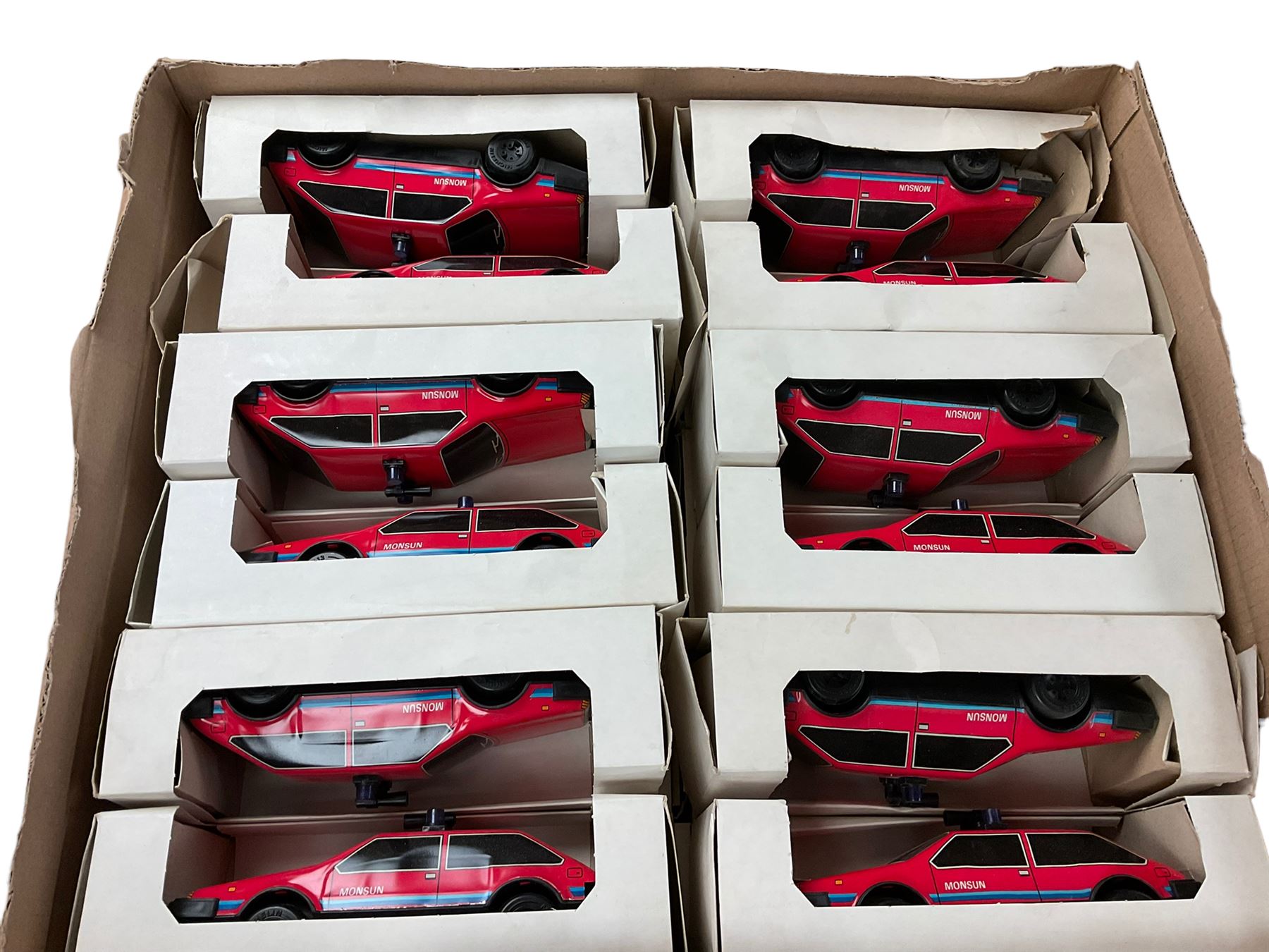 Twenty four red tin plate cars, in boxes 