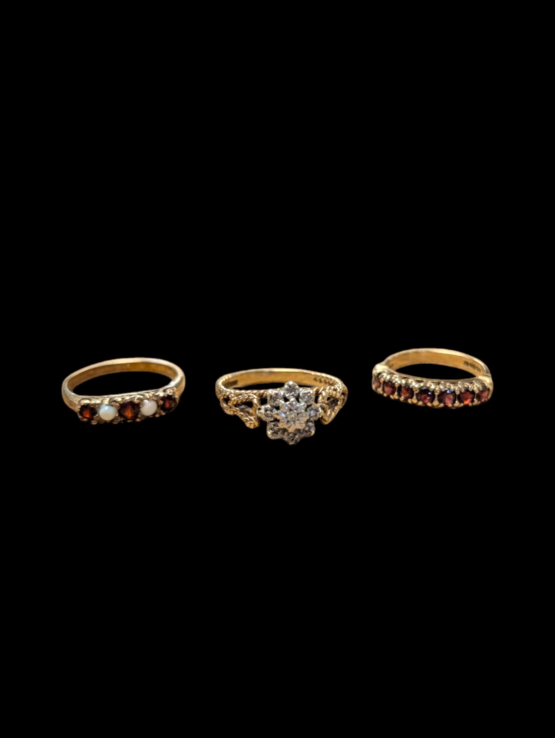 Two 9ct gold stone set rings, to include illusion set diamond cluster ring and seven stone garnet ring, both hallmarked, together with a silver-gilt stone set ring