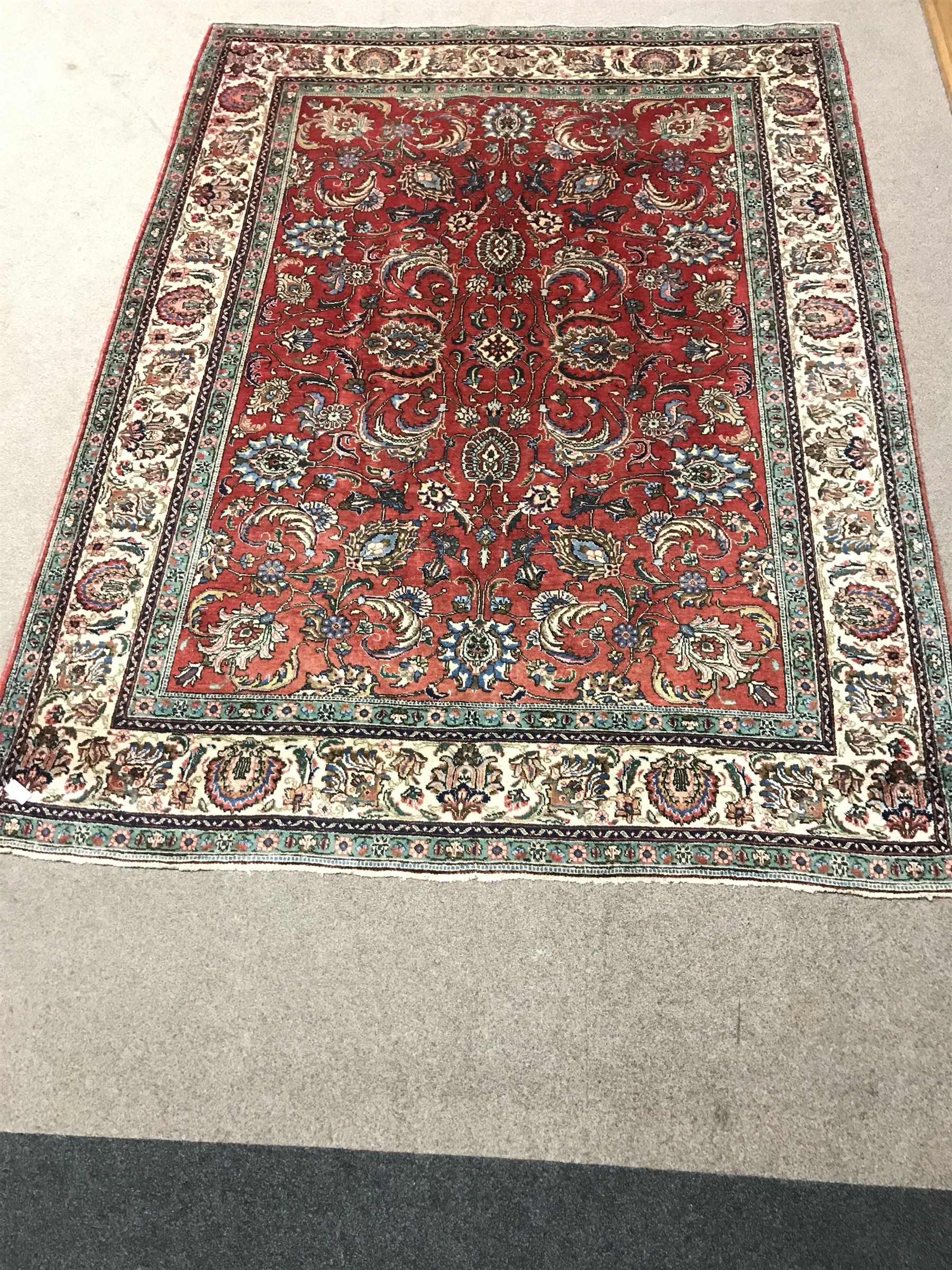 Persian Tabriz red ground carpet, central medallion, repeating border, 355cm x 270cm