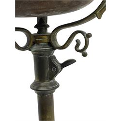 Victorian brass converted oil lamp stand, telescopic stem with scrolled uprights terminating to scrolled feet, dished base decorated with scrolling cast metal work and grotesque masks 