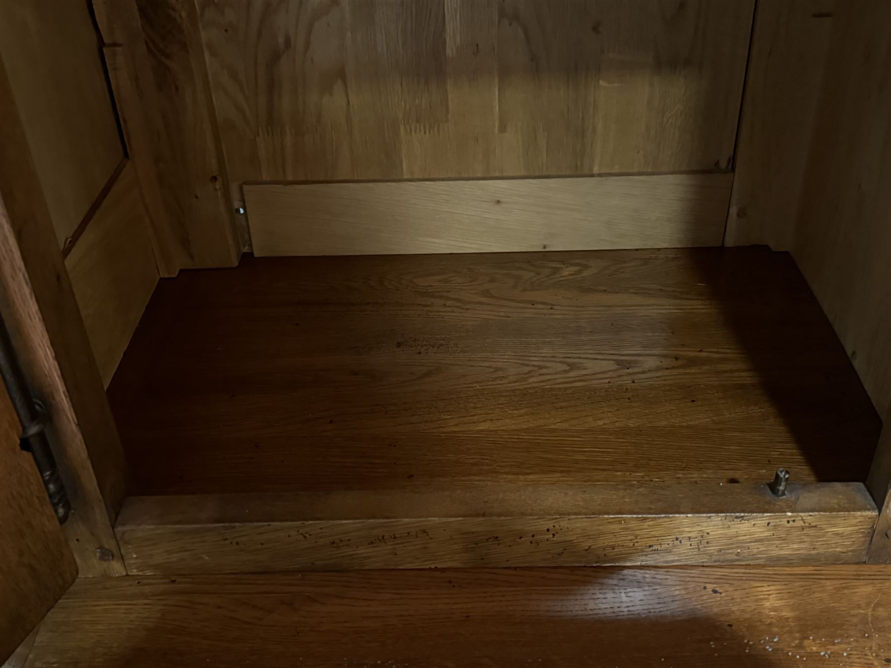 Large 20th century oak dresser, projecting cornice over open arched central section with two shelves, flanked by two panelled cupboards with two shelves, lower section with three drawers above three cupboards, on stile supports 