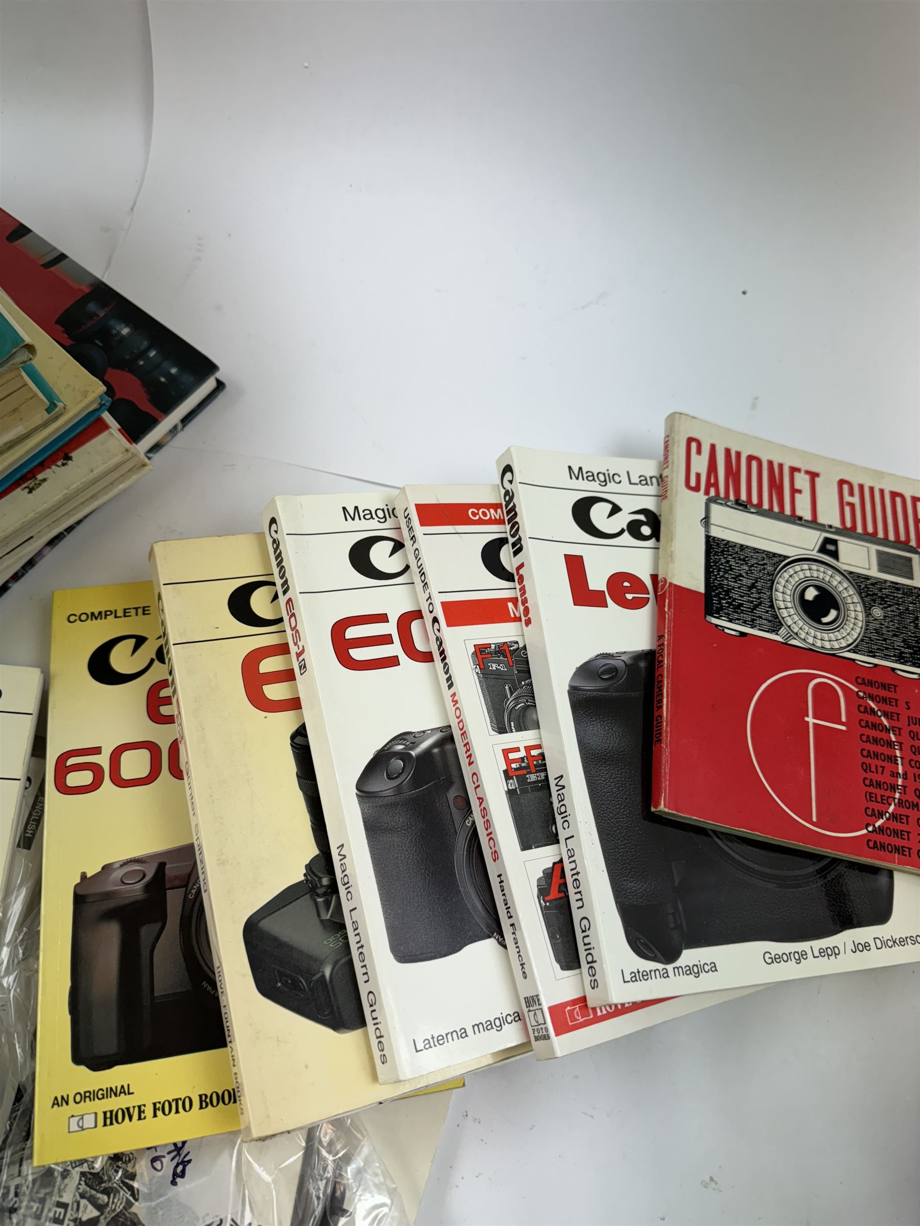 Large collection of Canon camera reference books, brochures, user's guides and instruction manuals, including Canon Compendium by Bob Shell, copies of Lens Wonderland, EOS camera guides, etc 