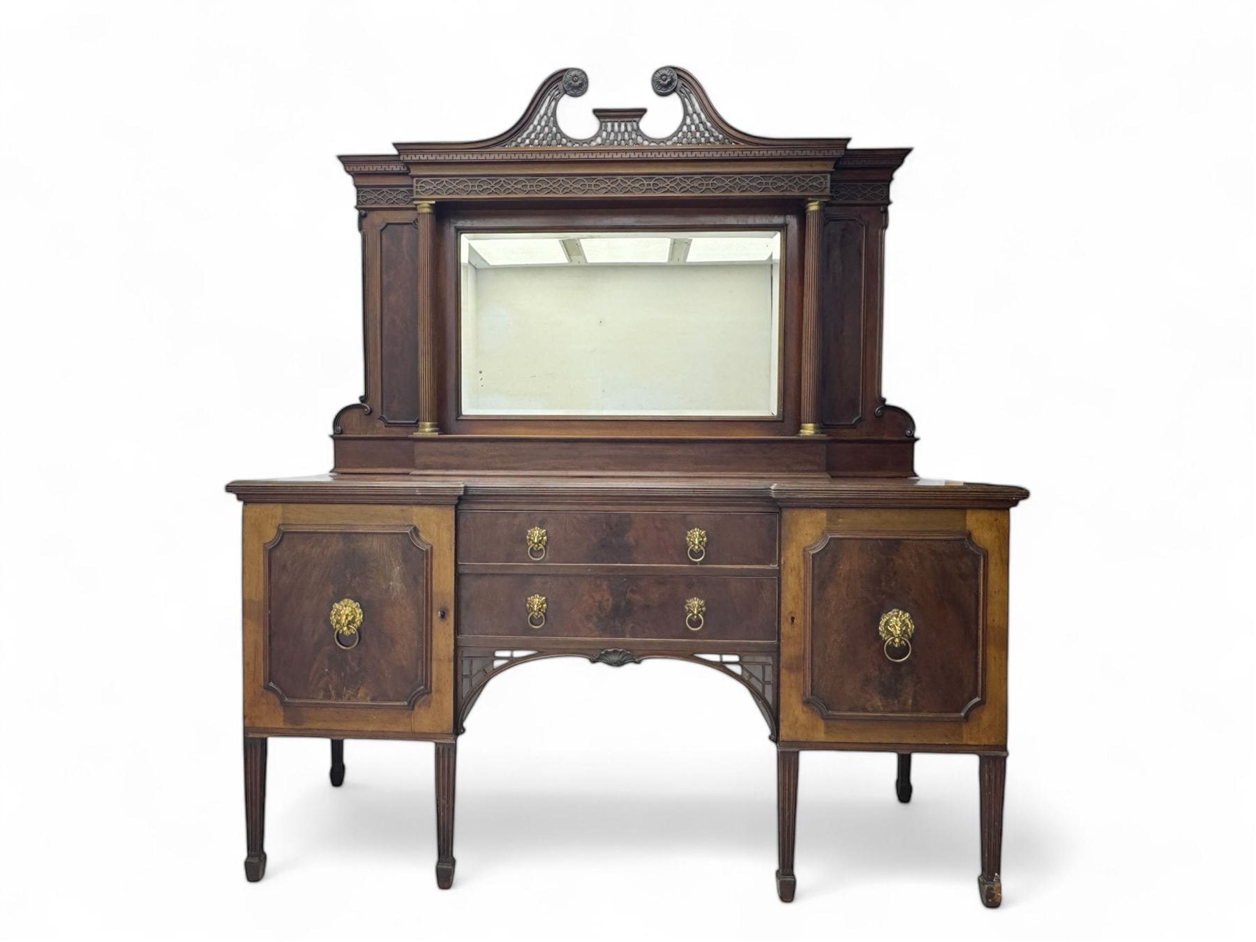 19th century mahogany sideboard, raised mirror back with carved fretwork and two fluted columns, above two cupboards and two drawers with lion mask handles