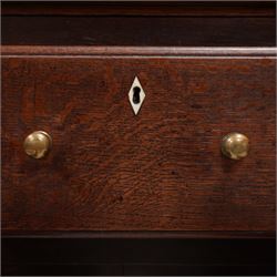 Late 18th century oak dresser, moulded cornice over three-tier plate rack, the base fitted with three drawers and two cupboards, enclosed by two panelled doors, on bracket feet, bone lozenge escutcheons 