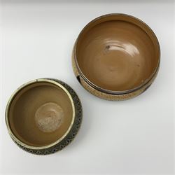 Two 19th century Doulton Lambeth bowls, each with silver plated rims, the first example decorated with vine leaves against a ditsy foliate backdrop, with impressed marks and monogrammed for George Hugo Tabor beneath, H13.5cm D23.5cm, the second example decorated with various foliate bands, with impressed marks and monogrammed for Louise E Edwards beneath, H13.5cm D17.5.