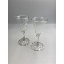 Pair of 18th century Liege wine glasses, circa 1730, with wrythen fluted trumpet bowls and knopped stems, H14.5cm