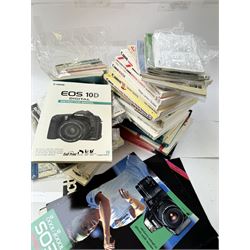 Large collection of Canon camera reference books, brochures, user's guides and instruction manuals, including Canon Compendium by Bob Shell, copies of Lens Wonderland, EOS camera guides, etc 