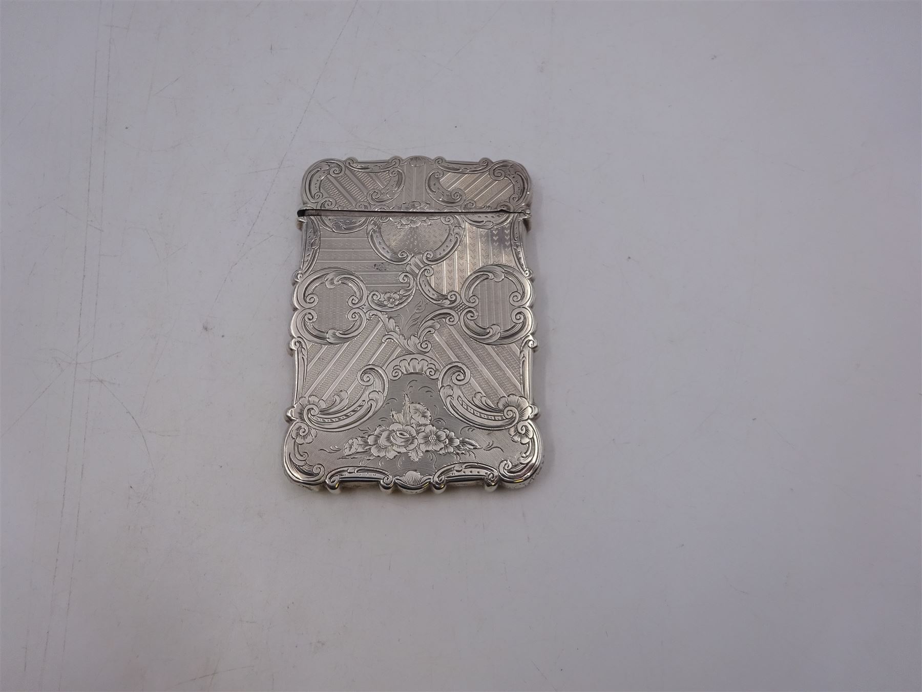 Victorian silver card case, of rectangular form with shaped edges, engine turned and floral decoration, with engraved hallmarked Nathaniel Mills, Birmingham 1845, H10cm