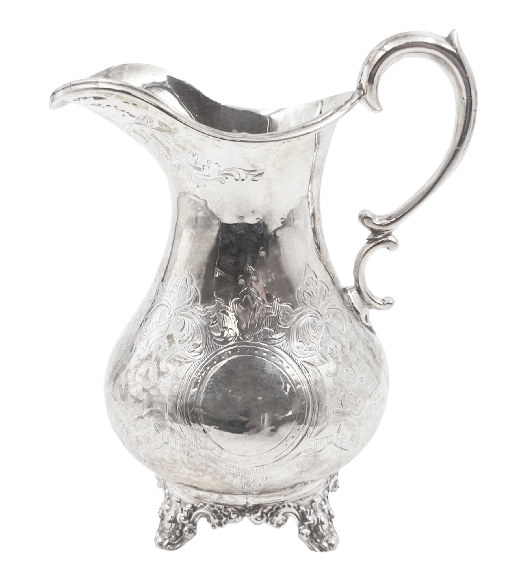 Victorian silver jug, of waisted form with C scroll handle, the body engraved with strapwork panels and circular cartouches, upon four embossed feet, hallmarked Charles Boyton, London 1864, H15.5cm