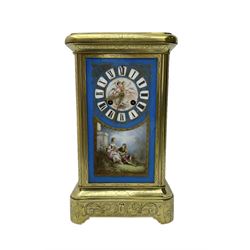 French - late 19th century 8-day mantle clock in an engraved brass corniche case with three rectangular porcelain panels decorated in the romantic Sevres style, dial with brass hands, cartouche Roman numerals and a depiction of cupid to the dial centre, rack striking movement sounding the hours and half hours on a bell. With pendulum.