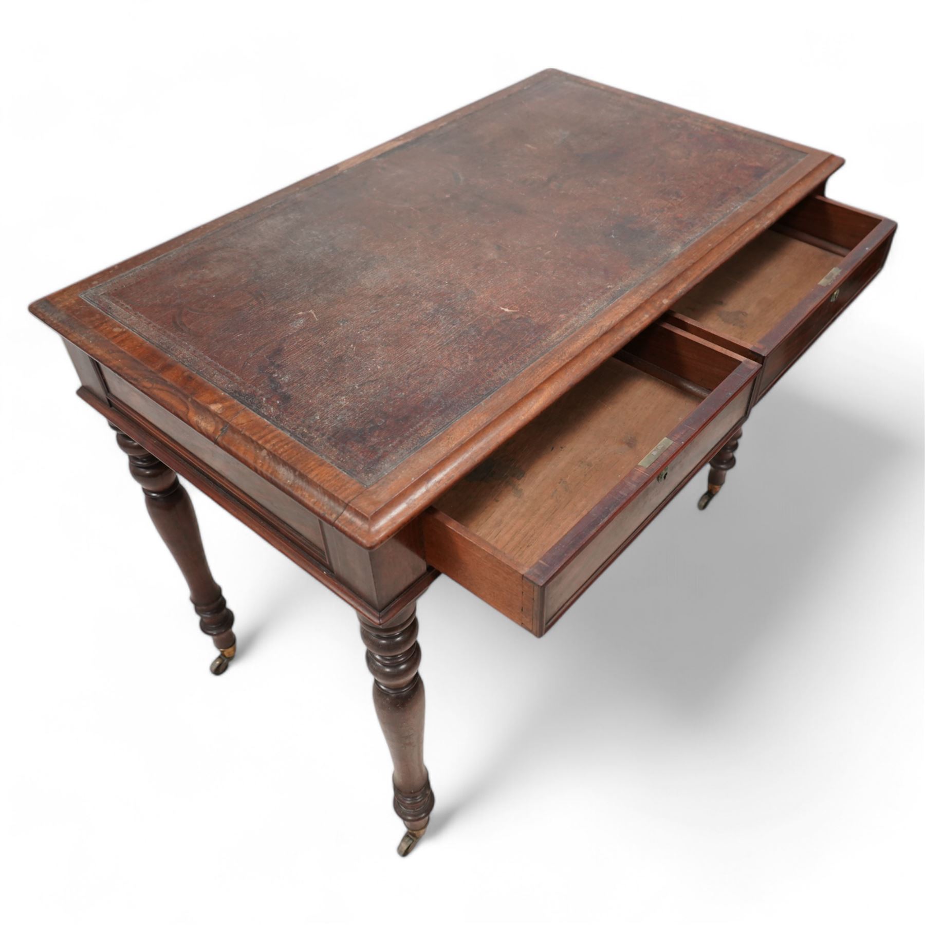 19th century mahogany writing table, rectangular top with moulded edge inset with leather writing surface, fitted with two frieze drawers with moulded facias, raised on turned supports terminating to brass cups and castors