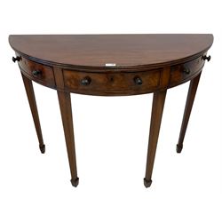 19th century mahogany demi-lune side or console table, reeded edge over central frieze drawer flanked by two hinged drawers with cock-beaded facias and turned handles, raised on square tapering supports with spade feet, the rear supports and feet chamfered in profile