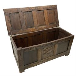 17th century oak blanket chest, quadruple panelled hinged lid over triple panelled front, lunette carved frieze and lower rail, the stile supports carved with scrolled strapwork, moulded frame