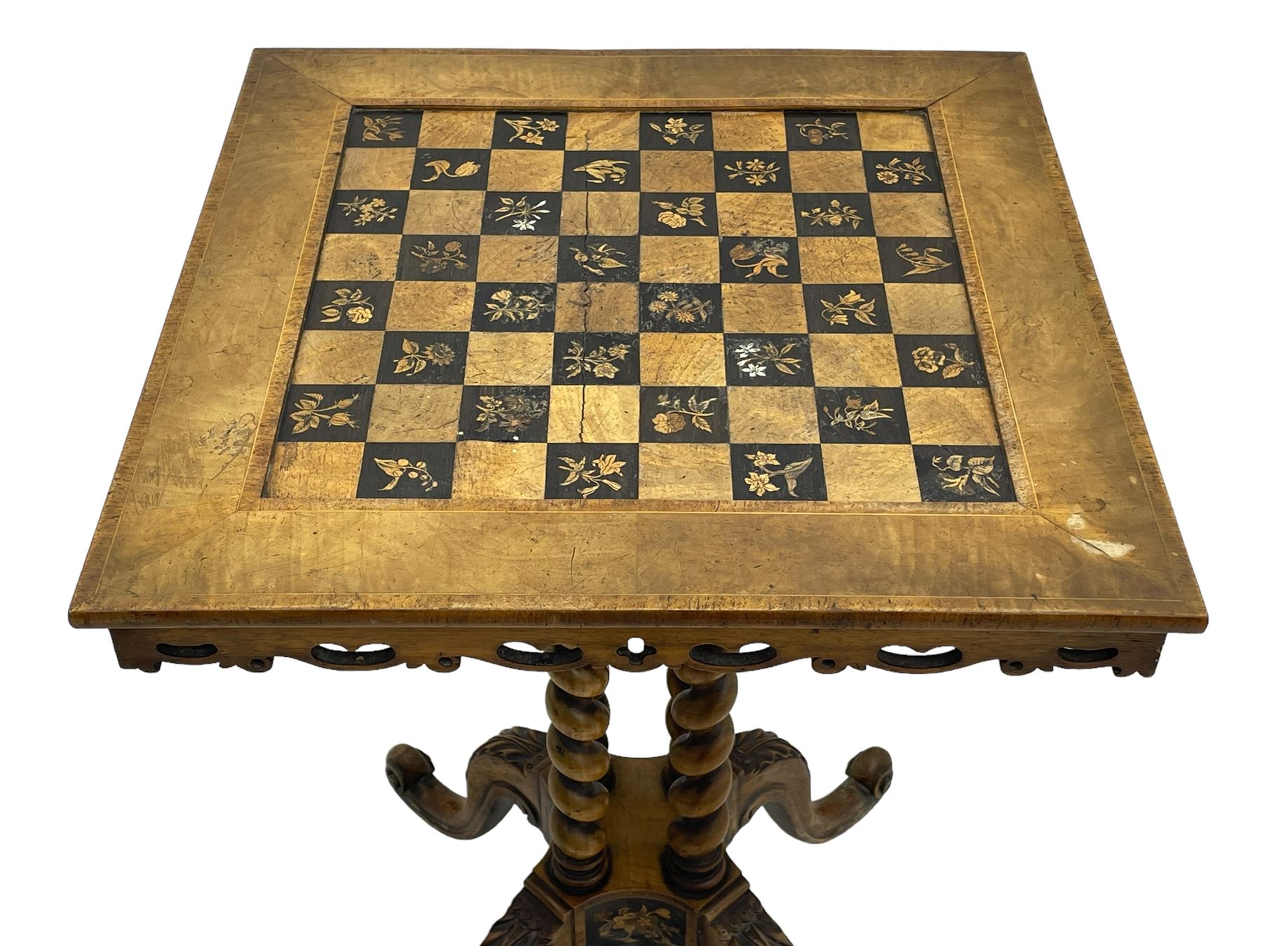 Late 19th century walnut games table, the square top with sunken inlaid chessboard decorated with inlaid floral bouquets, shaped and pierced frieze rails, on quadruple spiral turned pillars, concaved square platform inlaid with flowers, on acanthus leaf carved splayed supports with scrolled terminals 