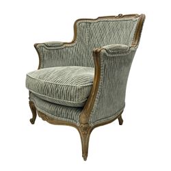 Colefax and Fowler - pair of French design beech framed armchairs, the moulded frame and cresting rail carved with flowers, scrolled arms and serpentine seats, cabriole supports with scroll carved terminals, upholstered in Colefax and Fowler fabric