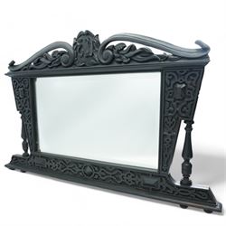 Late Victorian black painted mahogany wall mirror, scrolled pediment with central cartouch...