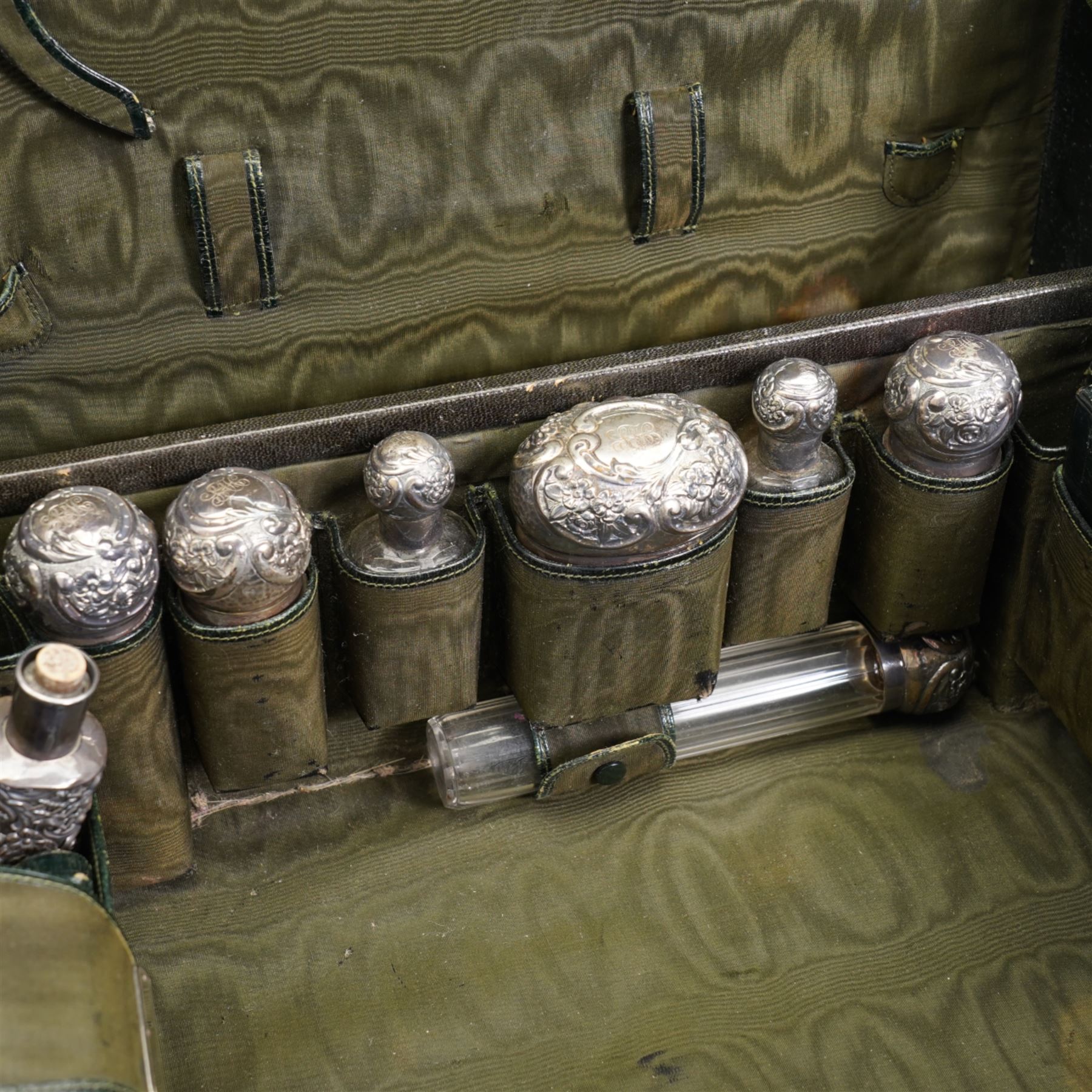 Edwardian ladies leather travelling dressing case by Army & Navy Co-operative Society, the watered silk interior with silver mounted glass bottles, leather jewellery box, leather folding stationery case and inkwell etc the silver hallmarked for London 1901 Maker Frederick Bradford Macrae 47cm x 33cm with outer canvas case